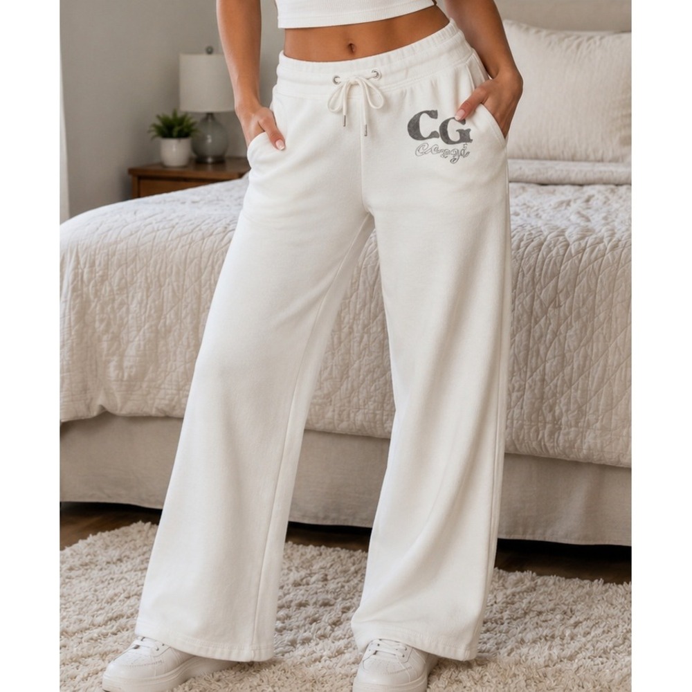 white Coogi brand fleece sweatpants with a distressed "CG" and script logo print